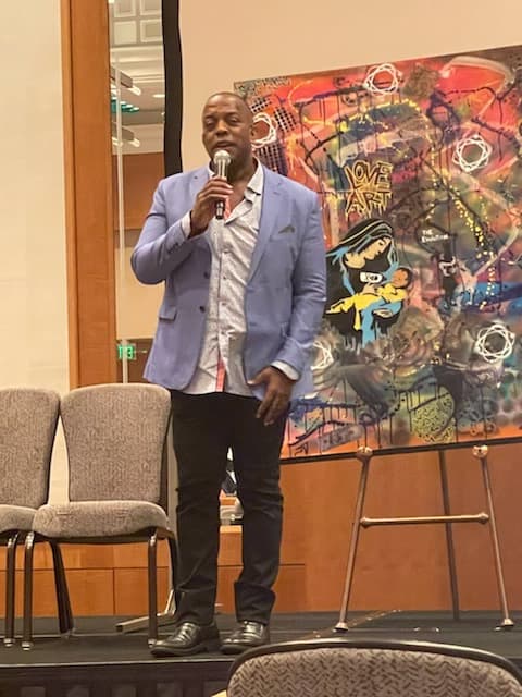 Wali Waiters speaking onstage — book Wali to speak
